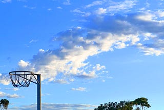 An old netball ring with clouds in the background — it’s like a boiling pot giving off steam.