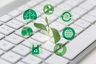 a tiny plant pops out from a computer keyboard with icons of sustainability depicted around it