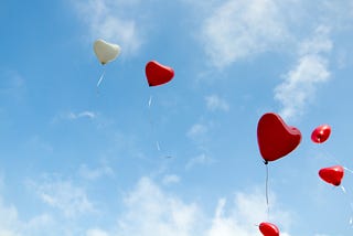 Heart shaped balloons floating into the sky