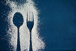 White powder (flour? sugar? cocaine?) making outline of spoon and fork