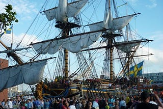Huge sailing ship with the crowd of people surrounding its base