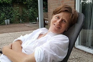 Cecile Janssens relaxes outside with a glass of white wine at her home in Stille Wille, The Netherlands.
