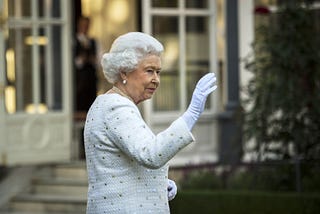 Queen Elizabeth II waving her hand.