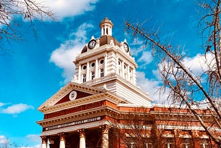 County courthouse with blue skies and white clouds in the background