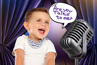This is a digitally altered or stylized image featuring a young child with a delighted expression looking towards a vintage microphone. The child is smiling broadly and is wearing a white T-shirt with navy blue stripes at the neckline. There’s a speech bubble coming from the child with the text “Are you talkin’ to me?” The background has a theatrical look with deep purple curtains, giving the impression that the child is on stage or part of a performance.