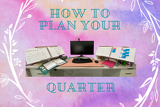 Planners surrounded by white flowers and branches on a computer desk