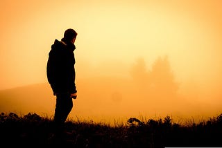 A man looking at the sunset.