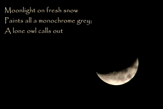 A photo of a crescent moon to the lower right-hand side of the image on a black background. The haiku is in the upper left. The photo was taken by the author on February 14, 2024.