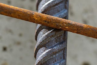 Why is steel used as reinforcement in concrete?