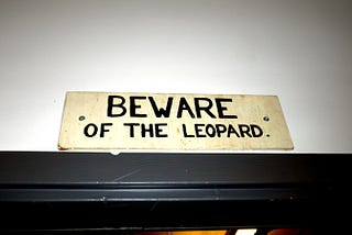 Beware of the Leopard sign above a door in the Imperial College Science Fiction Society, London, UK.
