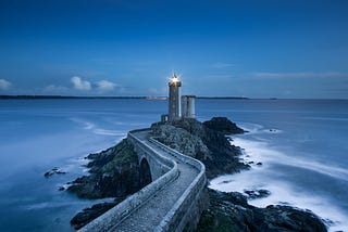 Lighthouse at the end of a breakwall