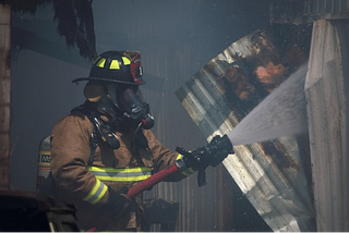 A firefighter extinguishing the fire on duty