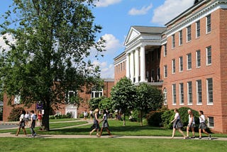 Students and teachers walking along paths on the main campus of The Ethel Walker School.