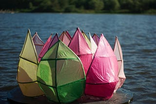 Plastic flower sculpture in a lake.