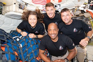 Astronauts Christina Koch, Jeremy Hansen, Reid Wiseman and Victor Glover pose for a photo together inside their Orion spaceship.