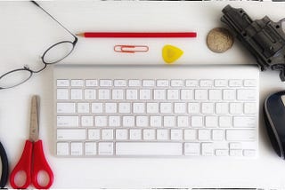 My writing desk. Keyboard, mouse, glasses, tools, pencil, and so on.