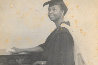 A graduation picture of a young smiling black woman.