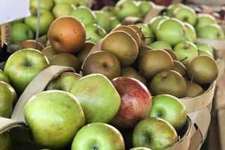 A variety of apples in a fresh produce market
