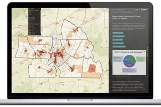 Photograph of a data dashboard that includes a map of counties, a pie chart, and text too small to read