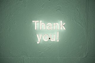 The words thank you brightly diaplayed on a dark background.