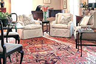 A living room with Persian rug and classic contemporary furniture.