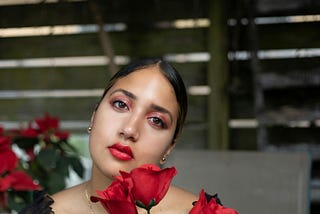 Woman with Red Eye Shadow Holding Red Roses