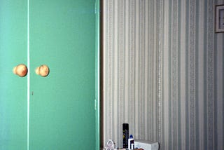 A bedroom in a bed and breakfast showing a wardrobe and a chest of drawers