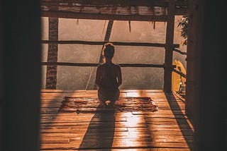 Women meditating overlooking the forest of her emotions