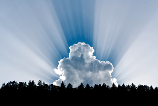 Photo of a cloud with sun rays.