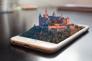 Fantasy castle emerging from the screen of a smartphone