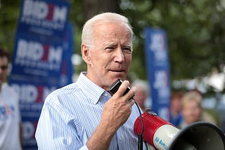 Joe Biden addresses a crowd using a bullhorn.