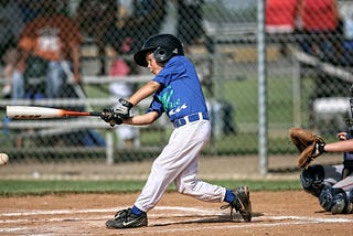 Kid playing baseball Photo by Keith Johnston on Unsplash