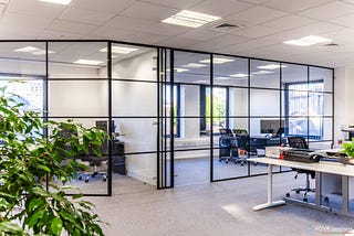 How can aluminium-framed glass partitions give aesthetic appeal?