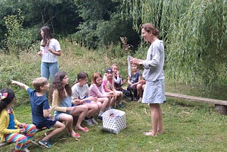 Children being taught outside.