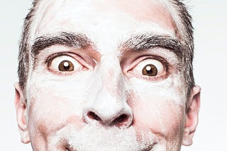 Man with white powder on his face