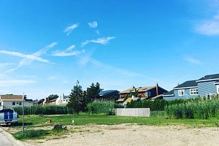 An empty couple of residential lots on a sunny day in South Lindenhurst, N.Y.