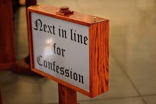 Sign that reads “Next in line for confession”