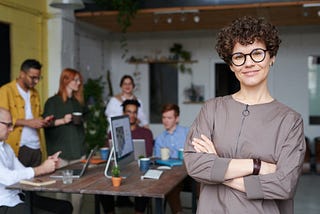 A woman with glasses at a team meeting