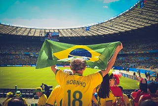 Brazil fan waving a flag at a game