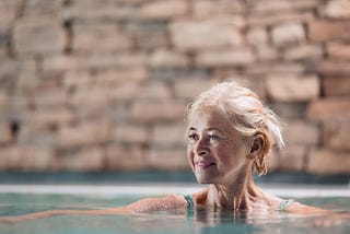 Older woman in hot springs water. Aging well.