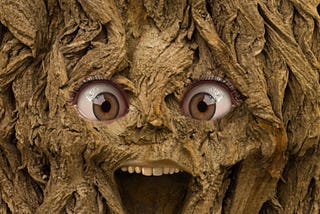 a face with a wide open mouth in a tree trunk