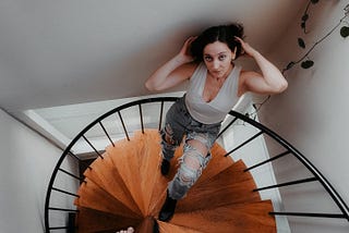 Brunette female in a spiral staircase.