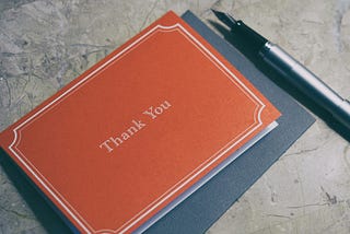 A thank-you note with a fountain pen next to it