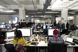 Completely open “cubicle hell” office with fifty or so desks