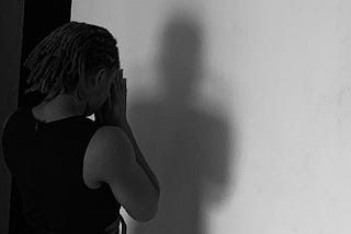 A picture of the Author- Keyu,  Facing the wall in prayer position as she seeks the forgiveness from self