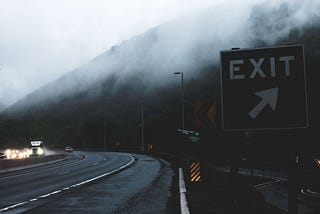 Exit sign on a dark highway