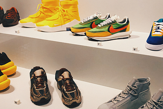 A collection of special edition, colourful sneakers in a cabinet space.