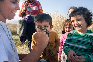 Students watch a bird ringing activity during “A day at the wetland”, organised by environmental group WWF. The same individual, an adult Fringilla coelebs, had been caught again in the same area last year. Lesvos, Greece, 2015, November 15