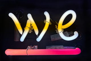 Neon spelling “WE”
