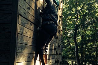 author climbing rock wall